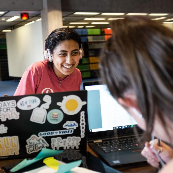 Students working on laptops in the library
